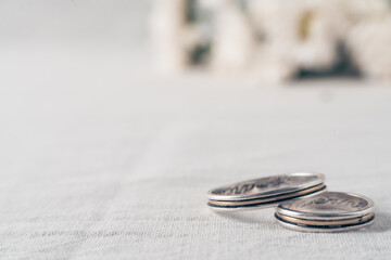 Close-up of a pair of wedding or engagement rings with an out of focus background of beautiful violet and white flowers and a large copy space.