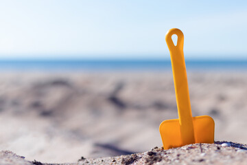 Children's toy in the sand on the coast