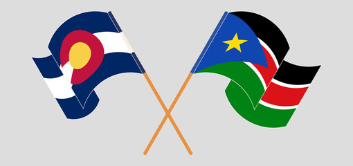 Crossed and waving flags of The State of Colorado and South Sudan