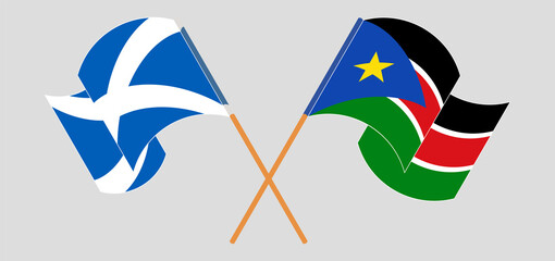 Crossed and waving flags of Scotland and South Sudan