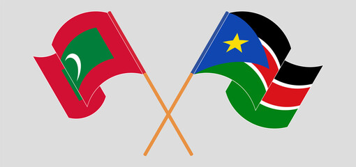 Crossed and waving flags of Maldives and South Sudan
