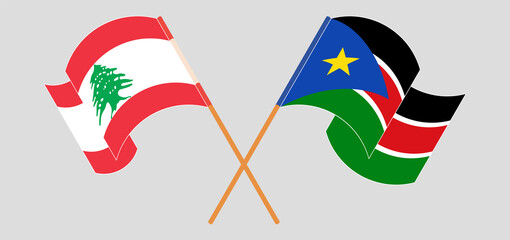 Crossed and waving flags of the Lebanon and South Sudan