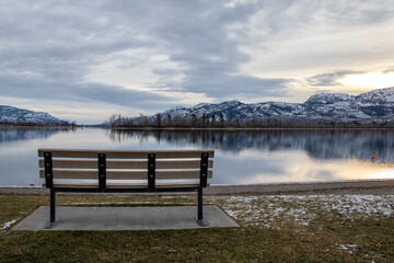 An empty park bench on a cold December day at Osoyoos Lake in BC, Canada