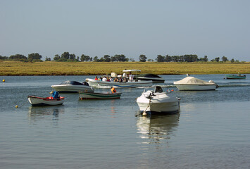 Fototapeta na wymiar Small boats at Ria Formosa, in Luz de Tavira district