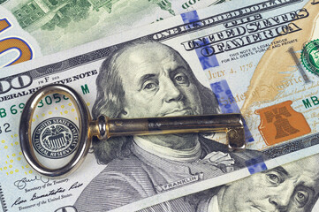 Key and 100 dollar bill. A symbol of wealth and success, the key to wealth.
