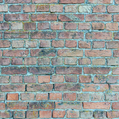 old stone wall made of weathered bricks as background