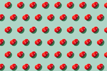 Easter background - pattern made of red Easter eggs on pastel mint background with copy space. Flat lay, selective focus