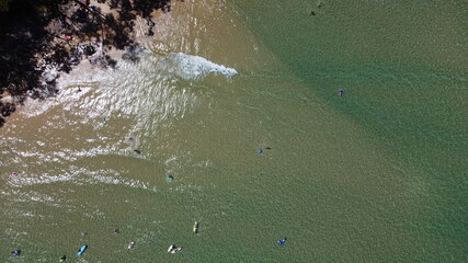 Sun-drenched aerial view of shallow water with rolling waves