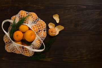 Fresh mandarin oranges fruit or tangerines on a wooden table. Christmas composition with tangerines, fir branches, cinnamon sticks. Flat lay, top view - 477521808