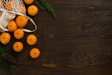 Fresh mandarin oranges fruit or tangerines on a wooden table. Christmas composition with tangerines, fir branches, cinnamon sticks. Flat lay, top view - 477521812