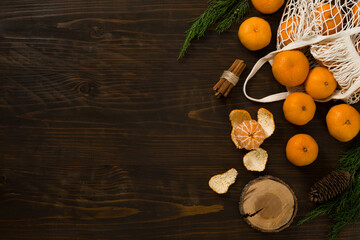 Fresh mandarin oranges fruit or tangerines on a wooden table. Christmas composition with tangerines, fir branches, cinnamon sticks. Flat lay, top view - 477521815