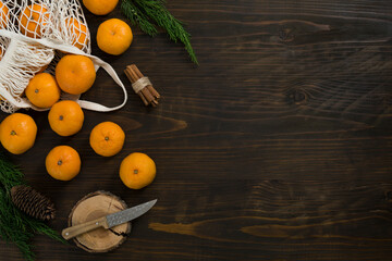Fresh mandarin oranges fruit or tangerines on a wooden table. Christmas composition with tangerines, fir branches, cinnamon sticks. Flat lay, top view - 477521826