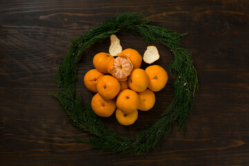 Fresh mandarin oranges fruit or tangerines on a wooden table. Christmas composition with tangerines, fir branches, cinnamon sticks. Flat lay, top view - 477521855