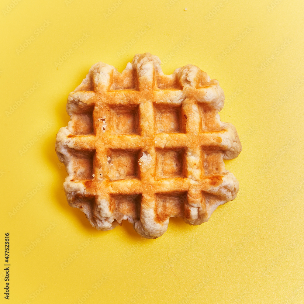 Sticker  Single delicious waffle over yellow background