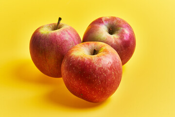 Group of red apples fruits over yellow background