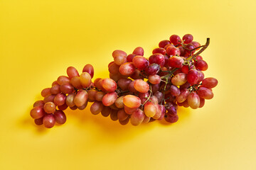  Bunch of grapes over yellow background
