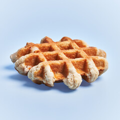  Single delicious waffle over blue background