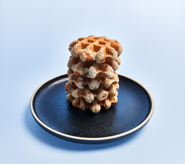  Plate of delicious waffles over blue background