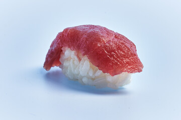  Single tuna nigiri sushi over blue background