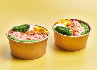  Two poke bowls over yellow background