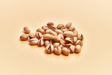  Bunch of pistachios over yellow background