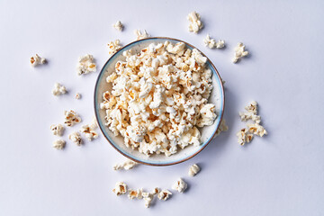  Bowl of salty popcorns isolated on a white background