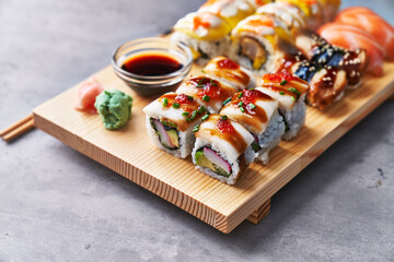  Wooden board of sushi food on a concrete surface