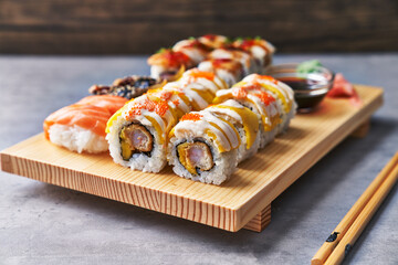  Wooden board of sushi food on a concrete surface