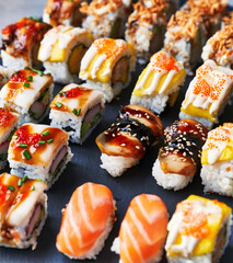  Group of sushi food rolls on a blackboard surface