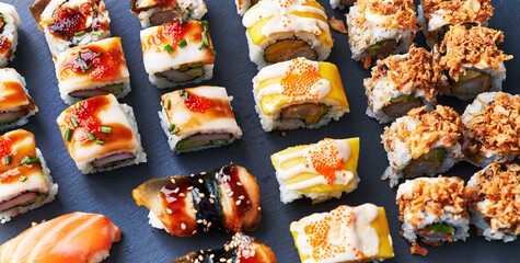  Group of sushi food rolls on a blackboard surface
