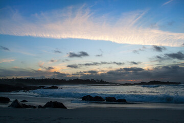 Dramatic cloudy sky under Pacific ocean at sunset