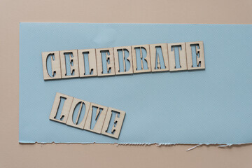 the expression "celebrate love" on fancy blue paper