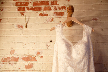 wedding dress hanging on a wall