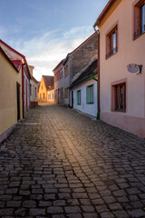 Fototapeta na wymiar Picturesque streets and decorative houses in Telc. The picturesque castle and the historic center with the decorative facades of the houses belong to the UNESCO World Heritage Site, Czech Republic.