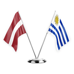 Two table flags isolated on white background 3d illustration, latvia and uruguay