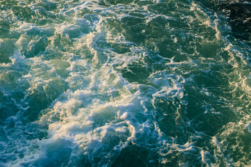 Fototapeta na wymiar Bubble and sea water foam texture in ocean green water.