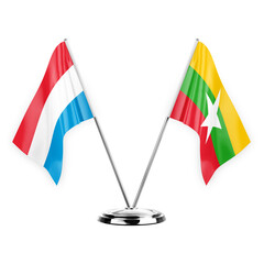 Two table flags isolated on white background 3d illustration, luxembourg and myanmar