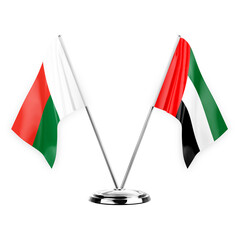 Two table flags isolated on white background 3d illustration, madagascar and united arab emirates