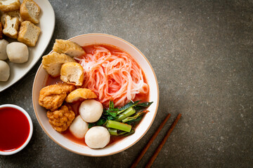 small flat rice noodles with fish balls and shrimp balls in pink soup, Yen Ta Four or Yen Ta Fo