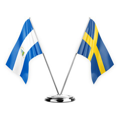 Two table flags isolated on white background 3d illustration, nicaragua and sweden