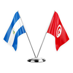 Two table flags isolated on white background 3d illustration, nicaragua and tunisia