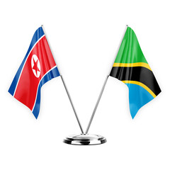 Two table flags isolated on white background 3d illustration, north korea and tanzania