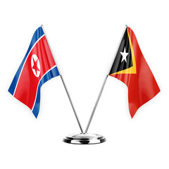 Two table flags isolated on white background 3d illustration, north korea and timor leste