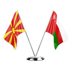 Two table flags isolated on white background 3d illustration, north macedonia and oman