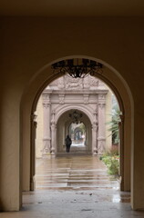 Alone person walking thru at El Prado colonnade on a rainy day