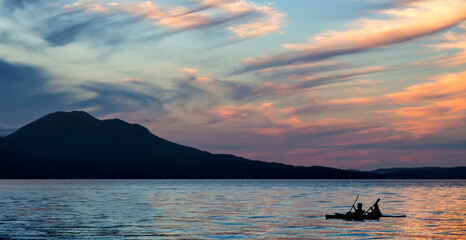 sunset over olympic mountains with kayak