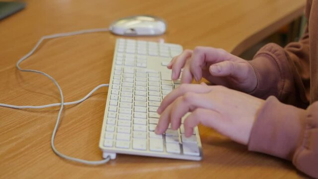 Closeup of hands type on keyboard on a desk. Concept hacker, blogger, work from home
