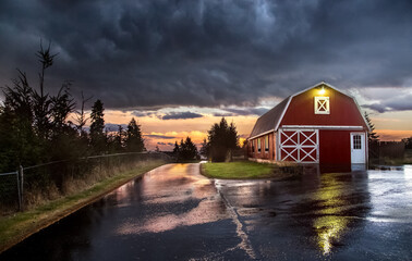 wet roads and red barn on rainy night - Powered by Adobe
