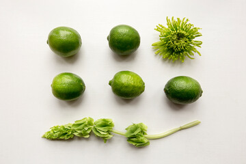 limes and flowers on white background