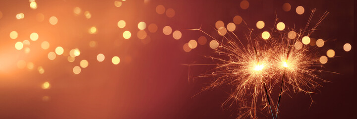 Fototapeta Happy New Year background with glowing sparklers. obraz
